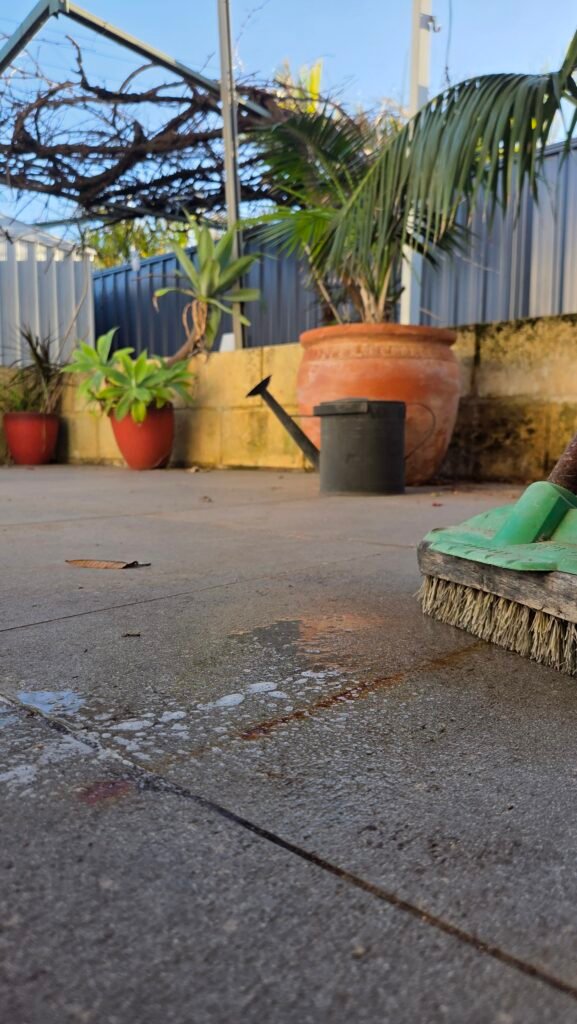 Rust stained patio tiles before cleaning